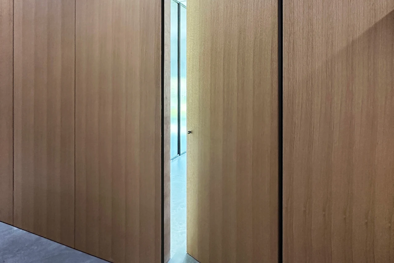 Wood-look concealed door and matching wall panels